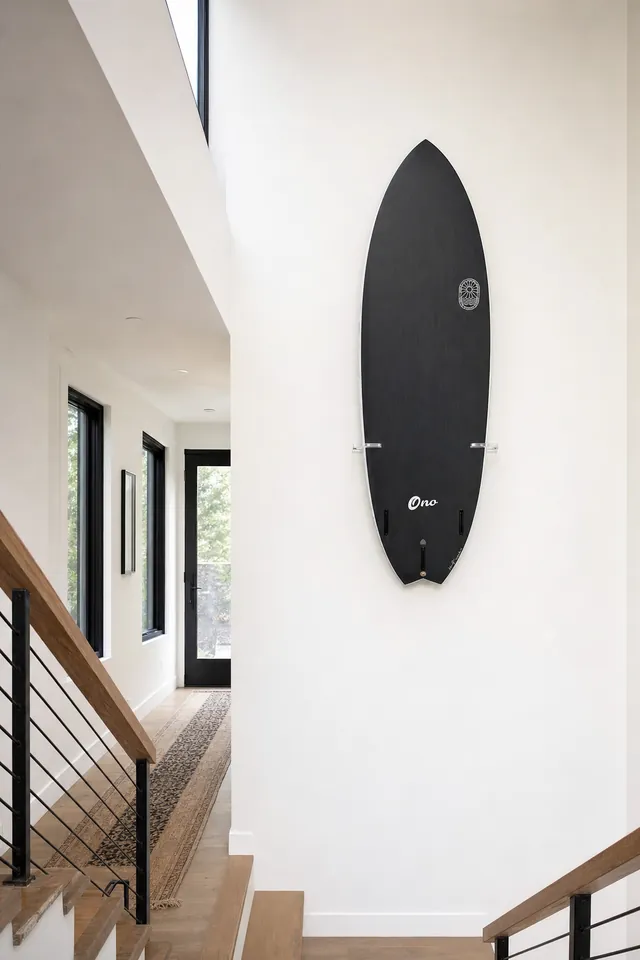 Stairwell with a surfboard mounted on the wall (AI-generated visualization)